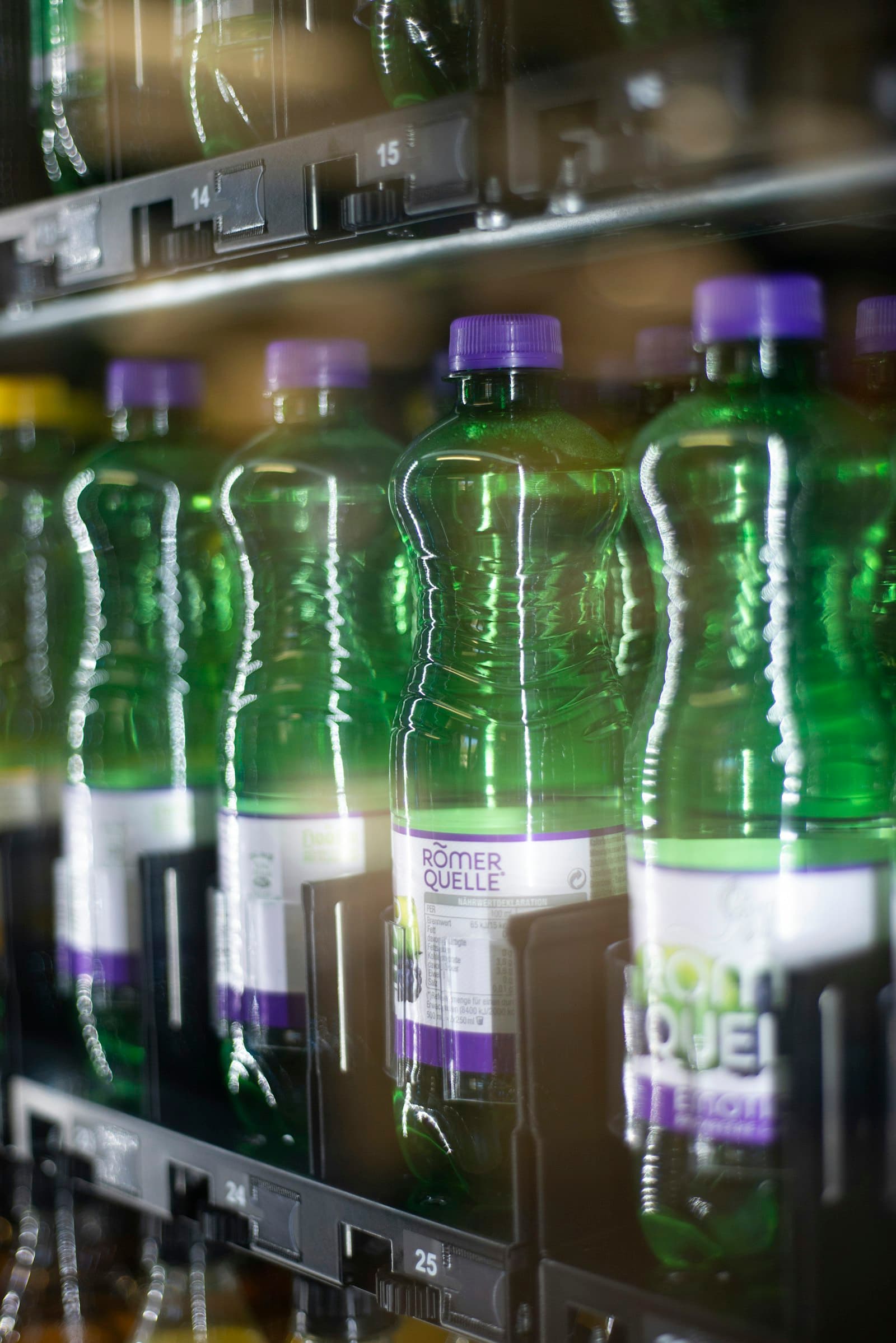 Packaged drinking water in green plastic bottles
