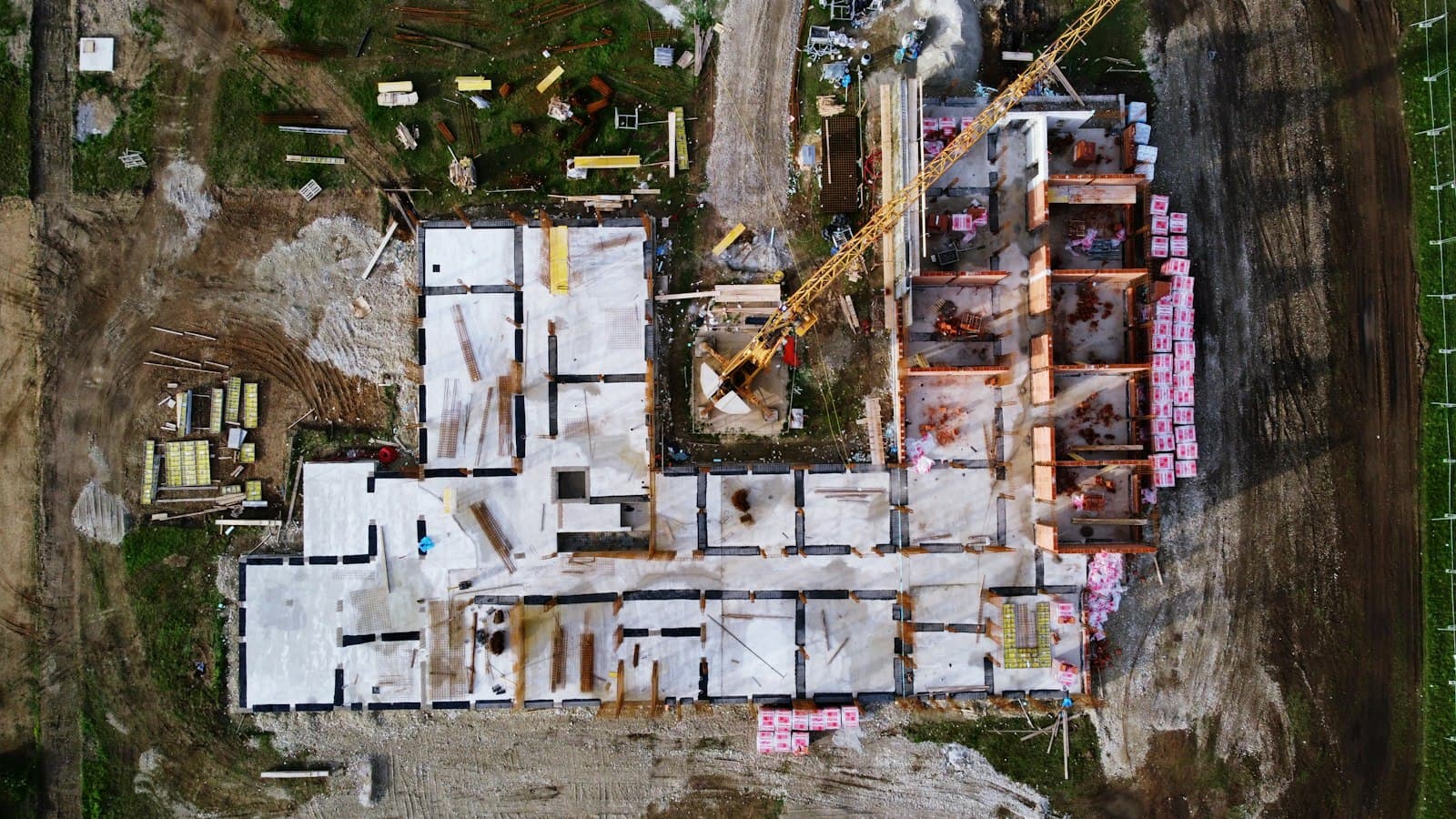 Aerial view of concrete foundation walls laid out on a construction site