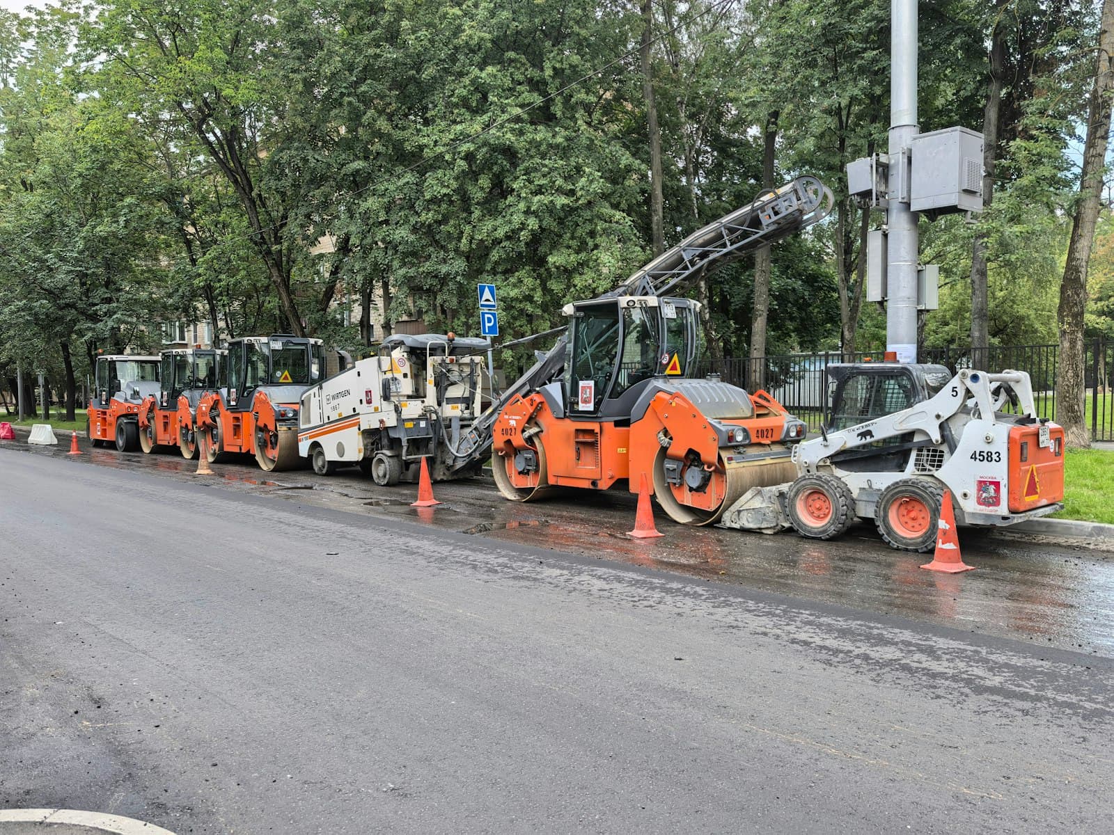 Road construction machinery lined up on a road under repair