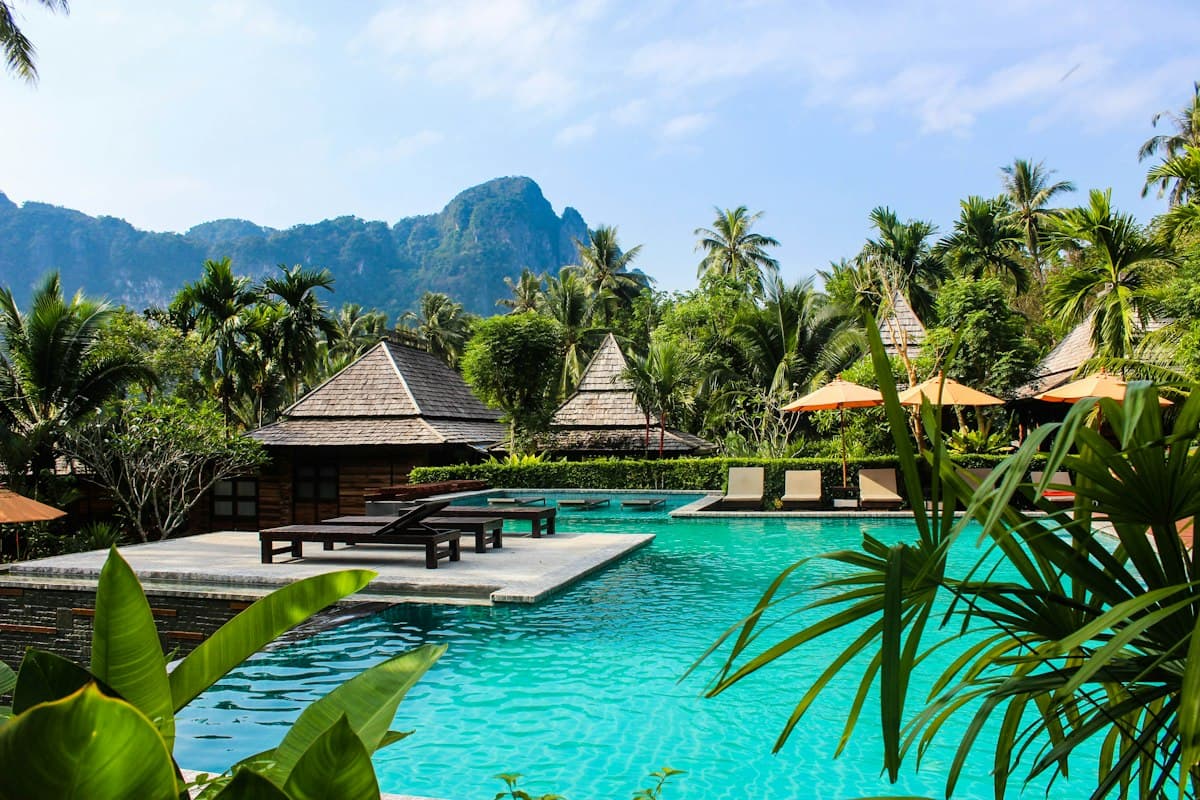 Resort pool among palm trees, for resort booking app development
